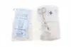 Two sealed packages of medical supplies, one containing face masks and the other containing bandages and scissors, are displayed against a white background. Náhled obrázku produktu