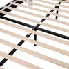 A close-up view of the wooden slats and metal frame of a bed base. Produktbild-Vorschau