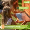 Two girls are interacting with a wooden chicken coop, with text overlays highlighting features. Produktbild-Vorschau