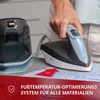 A person is using a steam ironing station on a striped shirt. Podgląd zdjęcia produktu