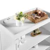 A close-up view of the top of a white cabinet, showing decorative items and storage. Produktbild-Vorschau