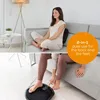 A woman is shown using a massage device in two different ways: sitting on a couch with a back cushion and standing with her feet on a foot massager. Produktbild-Vorschau