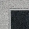 A close-up view of the corner of a carpet, showing the texture of the pile and the backing. Produktbild-Vorschau