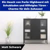 A black metal highboard with ribbed glass doors and drawers, displayed in a room setting with a plant. Produktbild-Vorschau