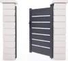 A modern gray aluminum garden gate is shown, partially open, between two white brick pillars. Produktbild-Vorschau