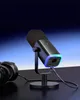 A black microphone with RGB lighting on a stand, next to a pair of black headphones on a dark surface, with a gradient blue background. Produktbild-Vorschau