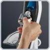 A hand is holding a small bottle of liquid and inserting it into a device. Produktbild-Vorschau