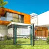 A modern house with a fence and gate in the foreground. Produktbild-Vorschau