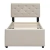 A beige upholstered bed frame with a tufted headboard and wooden slats for mattress support, shown from the front. Anteprima dell’immagine prodotto