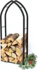 A black metal firewood rack filled with logs, with a small potted plant to the right. Podgląd zdjęcia produktu