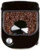 A top-down view of a black coffee maker filled with coffee beans. Podgląd zdjęcia produktu