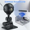 A black mini Wi-Fi surveillance camera is shown on a stand, with a diagram illustrating its wireless connectivity to a home interior. Produktbild-Vorschau
