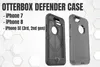 Two Otterbox Defender cases for iPhones are shown against a white and light gray background with hexagonal patterns. Náhled obrázku produktu