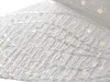 A close-up view of a white paper Christmas star decoration with small circular cutouts and decorative stitching. Voir les images du produit