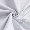A close-up view of white fabric with a silver marbled pattern, folded and swirled. Produktbild-Vorschau