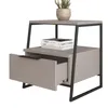 A modern nightstand with an open drawer and a plant on top. Voir les images du produit