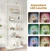 A tall glass display cabinet with multiple shelves, showcasing various decorative items. The right side of the image displays different color options for the LED lighting within the cabinet. Produktbild-Vorschau