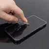 A hand is holding a key and pressing it against the screen of a smartphone, demonstrating the scratch resistance of a screen protector. Produktbild-Vorschau