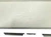 A white wall mount with a metal frame, shown against a white background. Below it are two pieces of metal. Produktbild-Vorschau