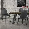 A dining set with chairs around a table, in front of a brick wall. Produktbild-Vorschau