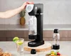 A person is using a soda maker in a kitchen setting. Produktbild-Vorschau