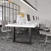 An office environment with a long white table and computers, set up for multiple users. Produktbild-Vorschau
