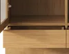 A close-up view of the interior of a wooden cabinet, showing a shelf and a drawer. Podgląd zdjęcia produktu