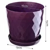 A purple plastic plant pot with a textured diamond pattern and a matching saucer, with dimensions indicated by white text and lines. Podgląd zdjęcia produktu