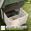 A close-up view of a wooden chicken coop with its nesting box open, showing the interior compartments. The coop is situated on a grassy lawn. Produktbild-Vorschau