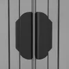 A close-up view of two black handles on a gray ribbed surface, likely a door or cabinet. Produktbild-Vorschau