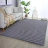 A living room setting with a sofa and a rug. Produktbild-Vorschau