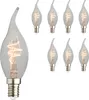 A collection of eight clear glass LED candle light bulbs with a flame-shaped top and a spiral filament, arranged in two rows on a white background. One bulb is larger and in the foreground on the left. Produktbild-Vorschau