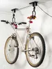 A bicycle is suspended from a ceiling-mounted lift system in what appears to be a garage or storage area. Produktbild-Vorschau