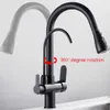 A black kitchen faucet with a pull-out spray head and a secondary spout, shown with a ghosted image of the spray head in a different position. Náhľad obrázku produktu
