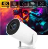 A white projector is shown in the foreground with a colorful, futuristic image of a person wearing a gas mask in the background. Overlay text highlights product features. Produktbild-Vorschau