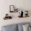 Three wooden shelves mounted on a white wall above a gray sofa. Voir les images du produit