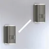 Two modern outdoor wall lights mounted on a gray wall. Produktbild-Vorschau