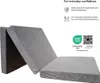 A gray folding mattress is shown in a slightly folded state against a white background. Text and logos are overlaid on the right side of the image. Voir les images du produit