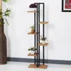 A multi-tiered plant stand with several potted plants on a white and gray background. Produktbild-Vorschau