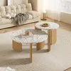 A living room scene with a couch and two round coffee tables. Voir les images du produit