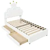 A white twin bed frame with a crown-shaped headboard and two drawers underneath, shown from a diagonal angle against a white background. Anteprima dell’immagine prodotto