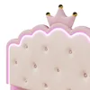 A close-up view of a pink and white upholstered headboard with a crown detail and LED lighting. Náhled obrázku produktu