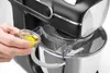 A close-up shot of a person's hand pouring liquid into a kitchen mixer. Voir les images du produit