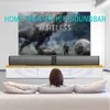 A person is sitting on a couch, facing a large TV screen and a soundbar. Produktbild-Vorschau