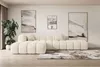 A modern living room with a large beige sectional sofa, abstract art on the wall, and a potted plant. Produktbild-Vorschau