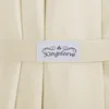 A close-up of a cream-colored fabric with a label that says "Kingsleeve". Produktbild-Vorschau