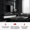 A modern bedroom with black 3D wall panels, a TV, and a bed. Produktbild-Vorschau