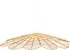 A hanging lamp made of woven natural fibers, shaped like a large flower or leaf. Produktbild-Vorschau