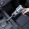 A hand is using a handheld vacuum cleaner to clean the interior of a car. Produktbild-Vorschau