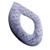 A close-up, angled view of a light blue, plush toilet seat cover against a white background. Produktbild-Vorschau